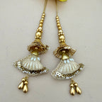Pair of gold and silver earrings on a light background