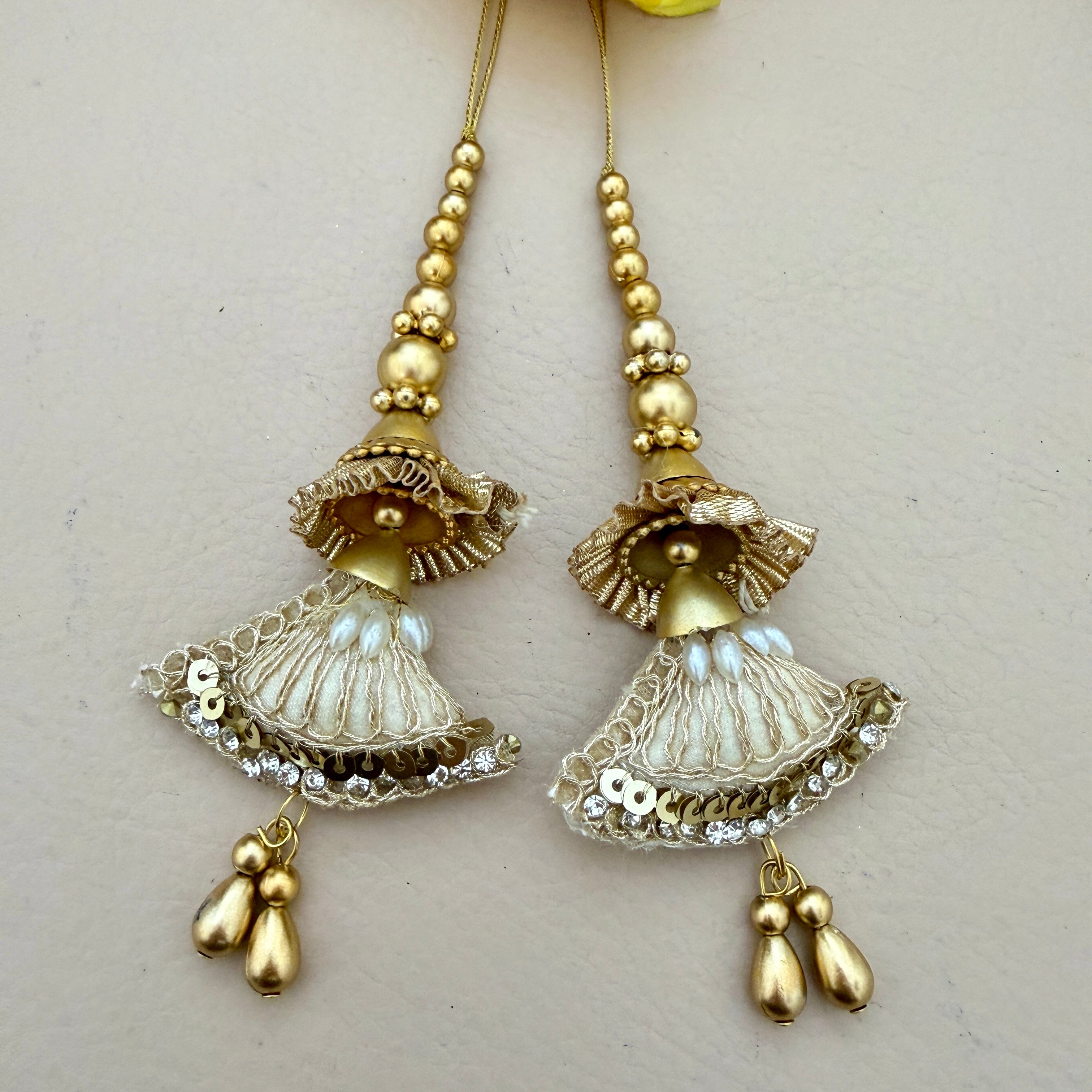 Pair of gold and silver earrings on a light background