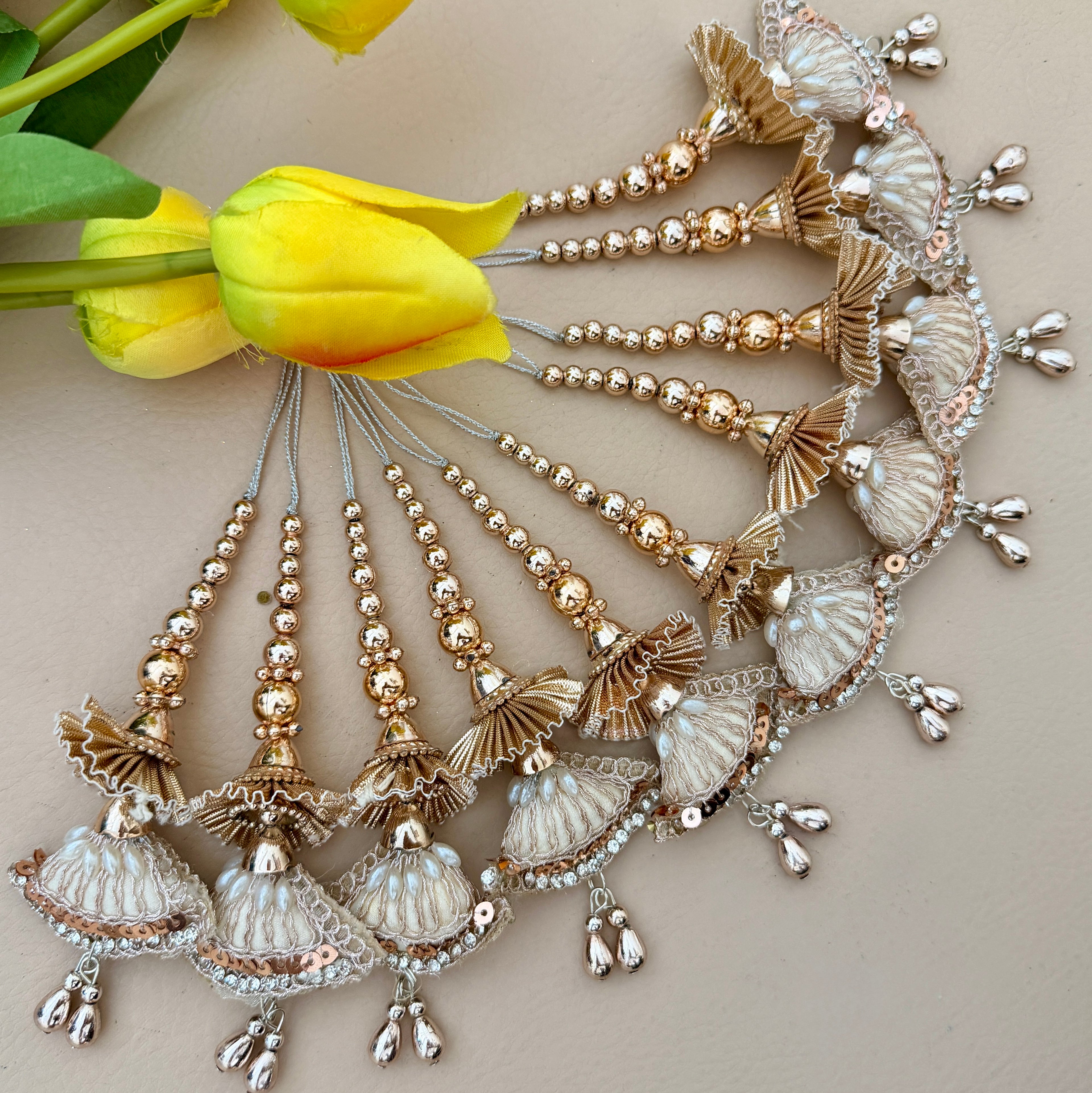 Decorative headpiece with gold and silver elements on a light background with yellow tulips.