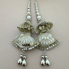 Pair of silver earrings with intricate designs on a light gray background