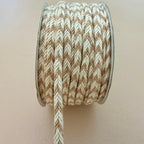 Spool of brown and beige braided cord on a plain background
