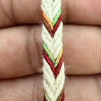 Close-up of a hand holding a colorful braided bracelet.