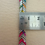 Colorful braided cord with a ruler for scale on a beige background