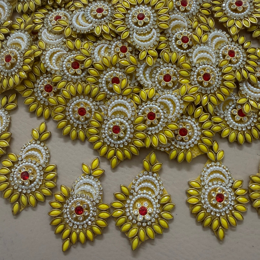 Decorative gold and pearl embellishments on a beige background