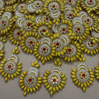 Decorative gold and pearl embellishments on a beige background