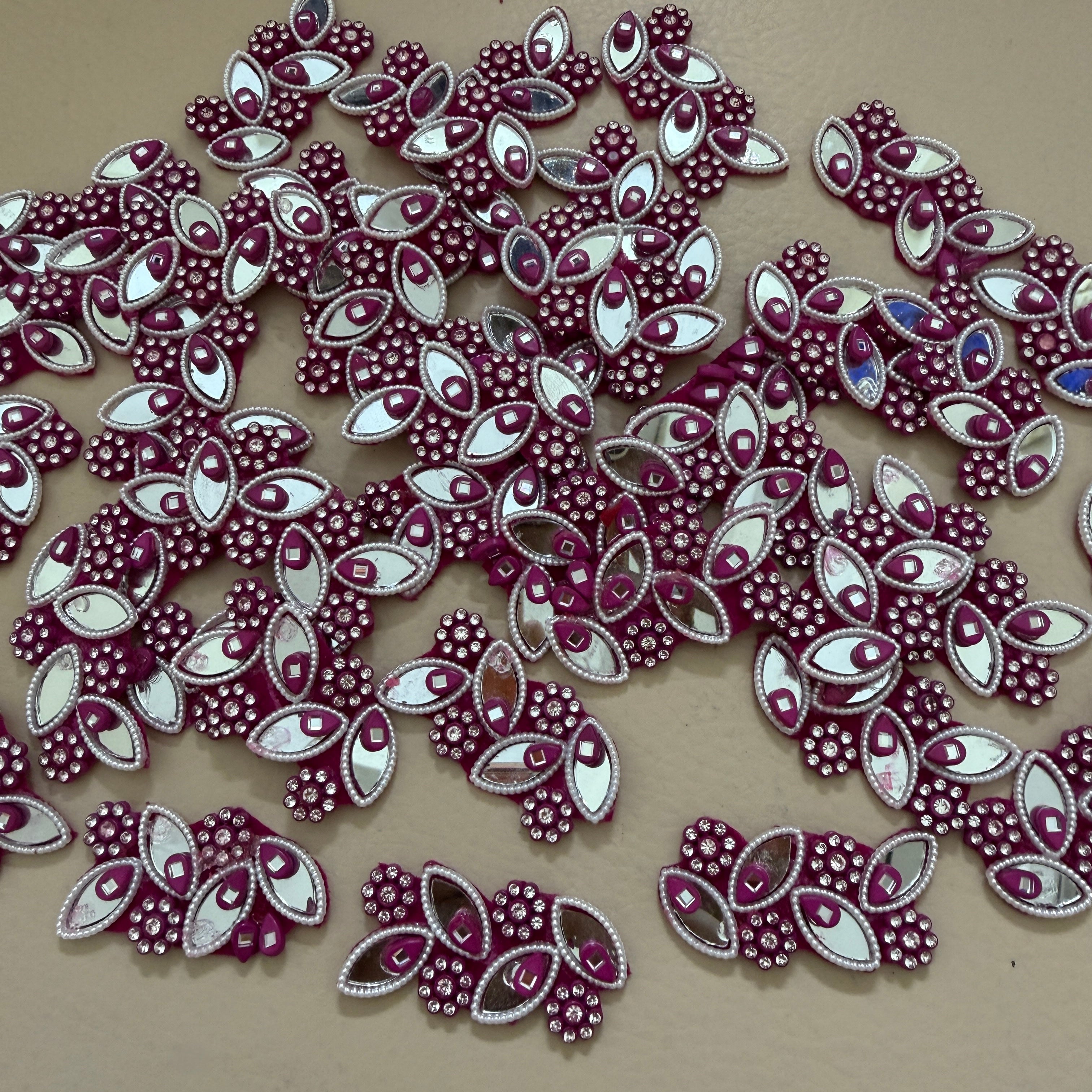 Decorative purple and white embellishments on a beige background
