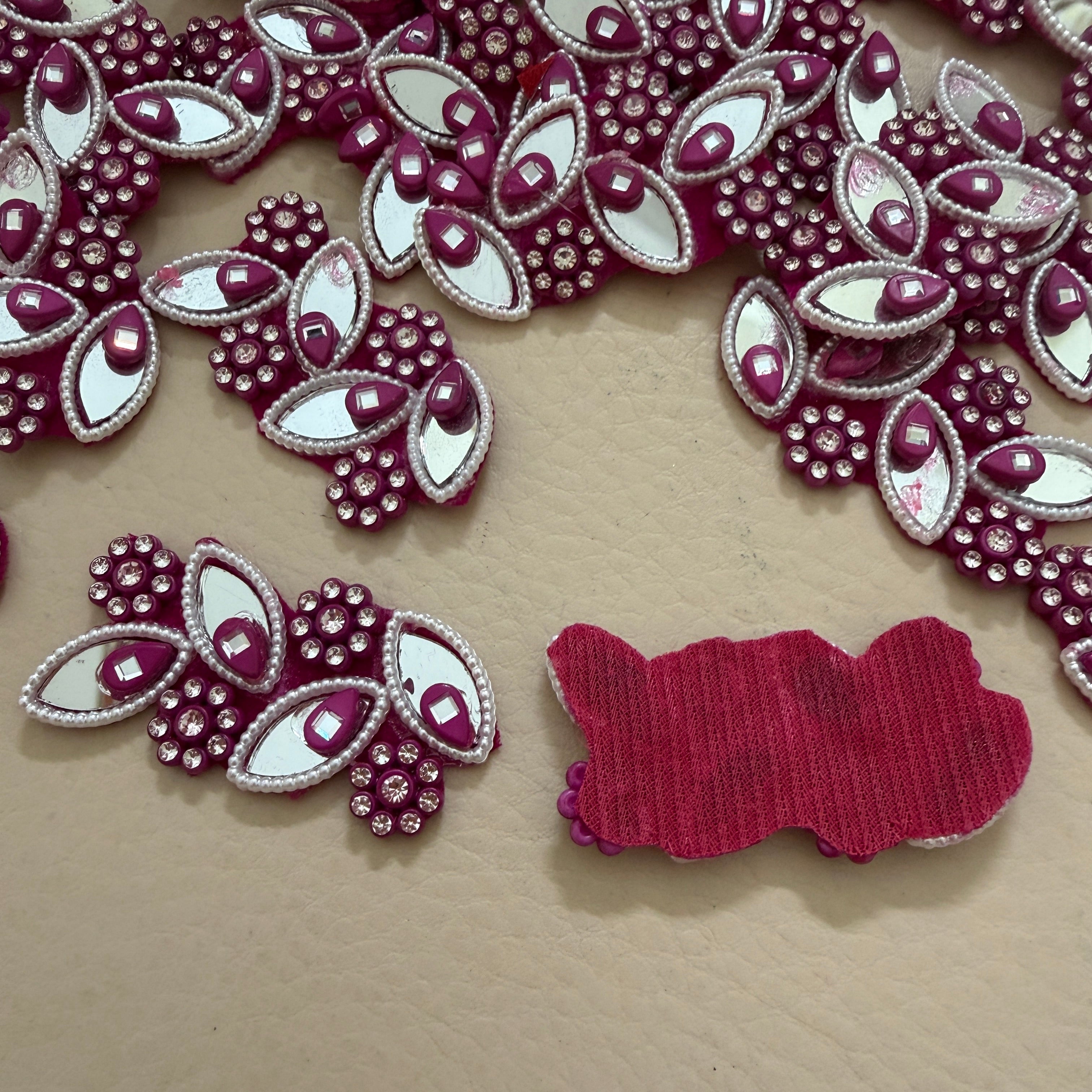Decorative red and white embellishments on a beige surface