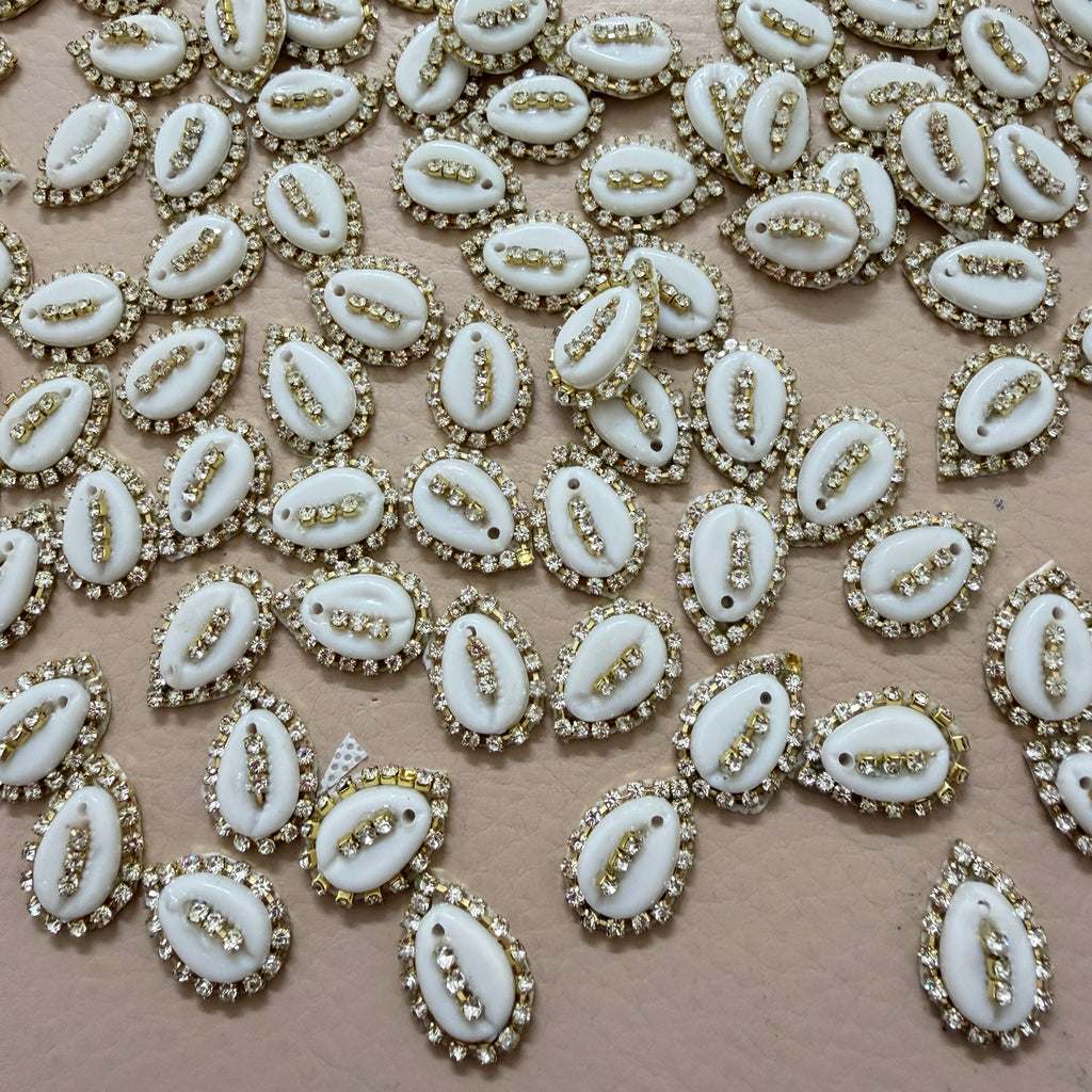 White embellishments with gold accents on a beige background