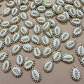 White embellishments with gold accents on a beige background