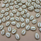 White embellishments with gold accents on a beige background