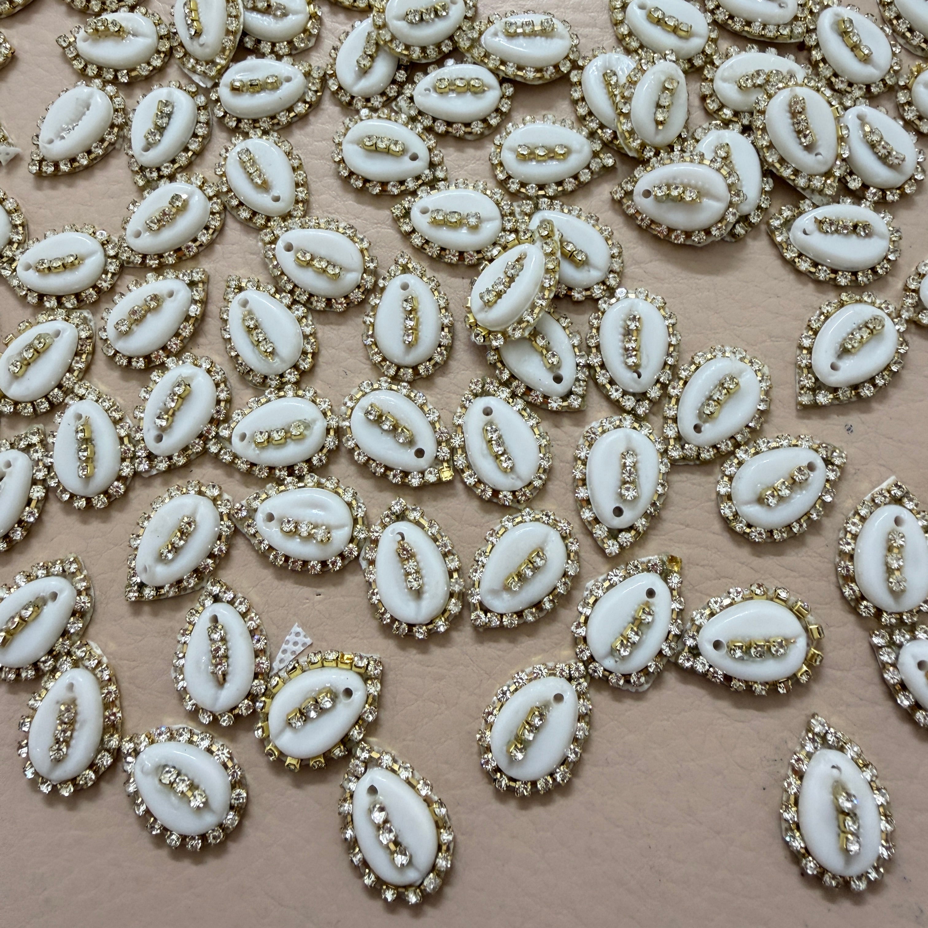White embellishments with gold accents on a beige background