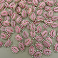 Pink embellishments with rhinestones on a beige background