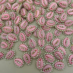 Pink embellishments with rhinestones on a beige background