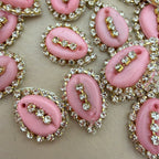 Pink rhinestone-encrusted buttons on a beige background