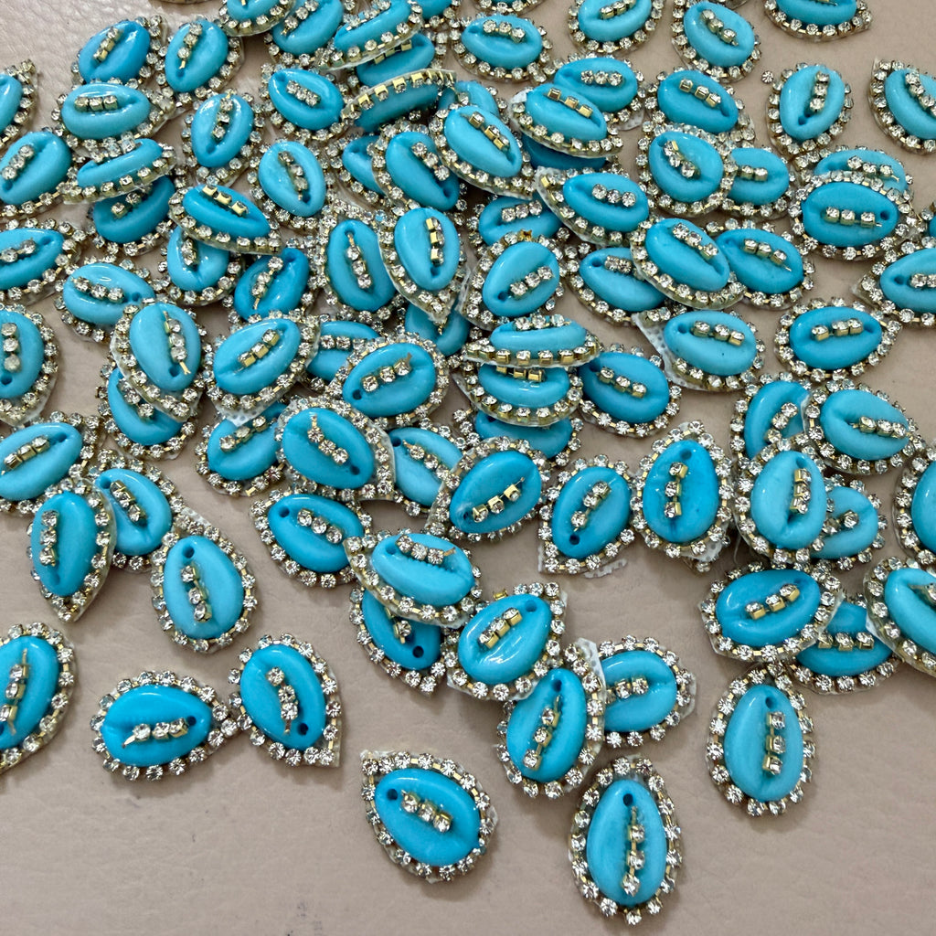 Blue decorative elements with rhinestones on a beige background