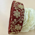 Decorative headband with floral embroidery on a white background