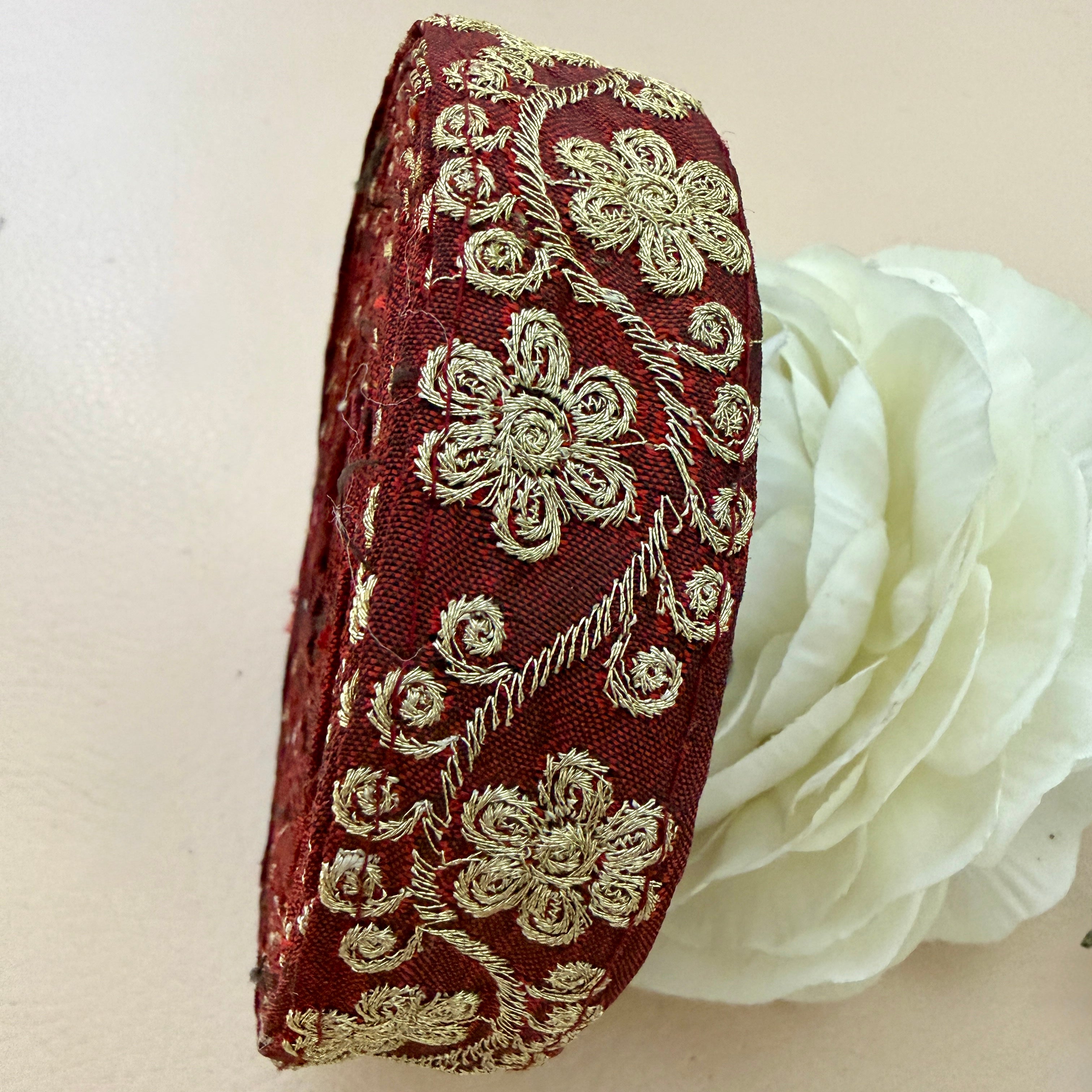 Decorative headband with floral embroidery on a white background
