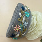 Embroidered beret with floral designs on a beige background