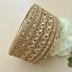 Decorative gold headband with intricate patterns on a light background