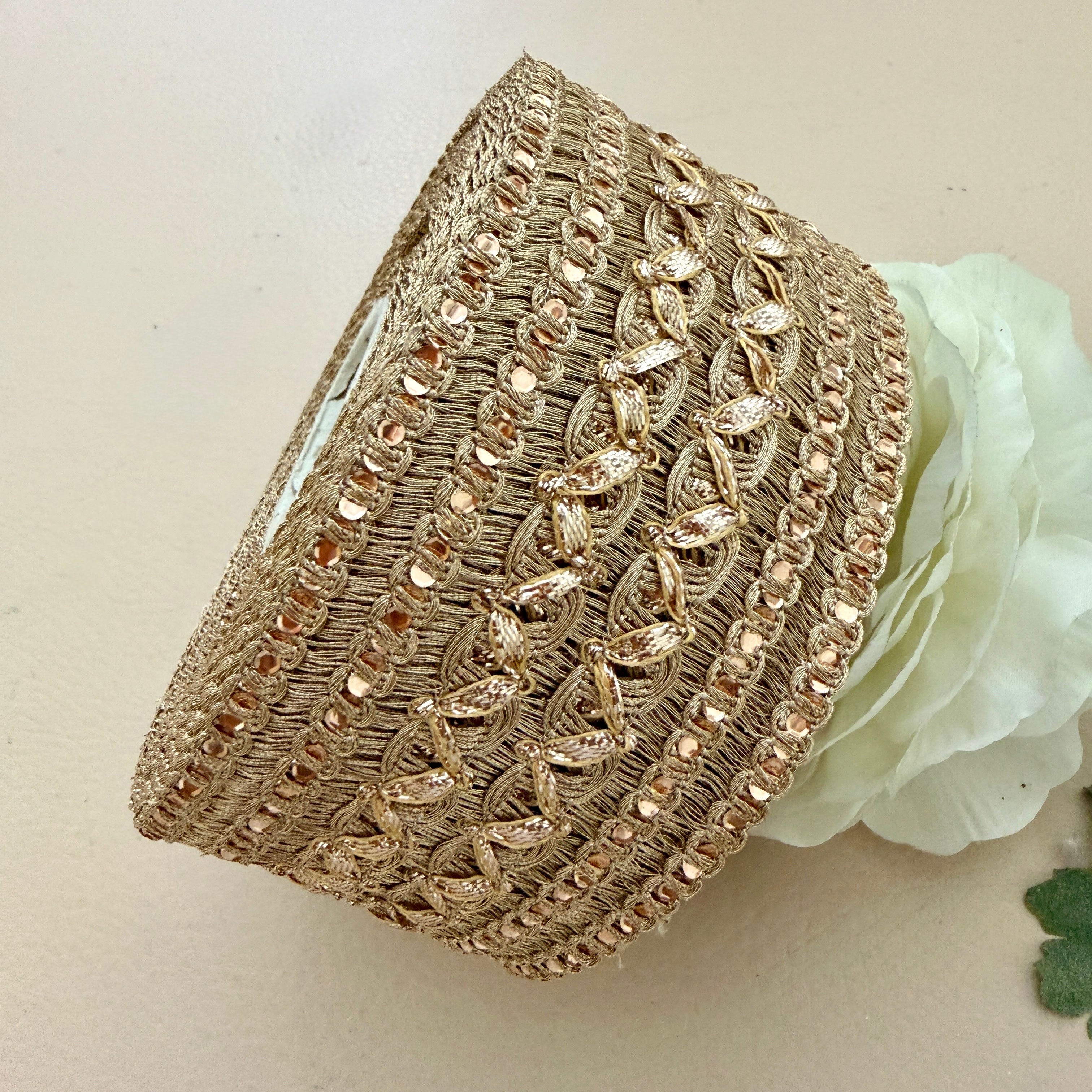 Decorative gold headband with intricate patterns on a light background