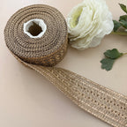 Roll of decorative ribbon with a white flower on a beige background