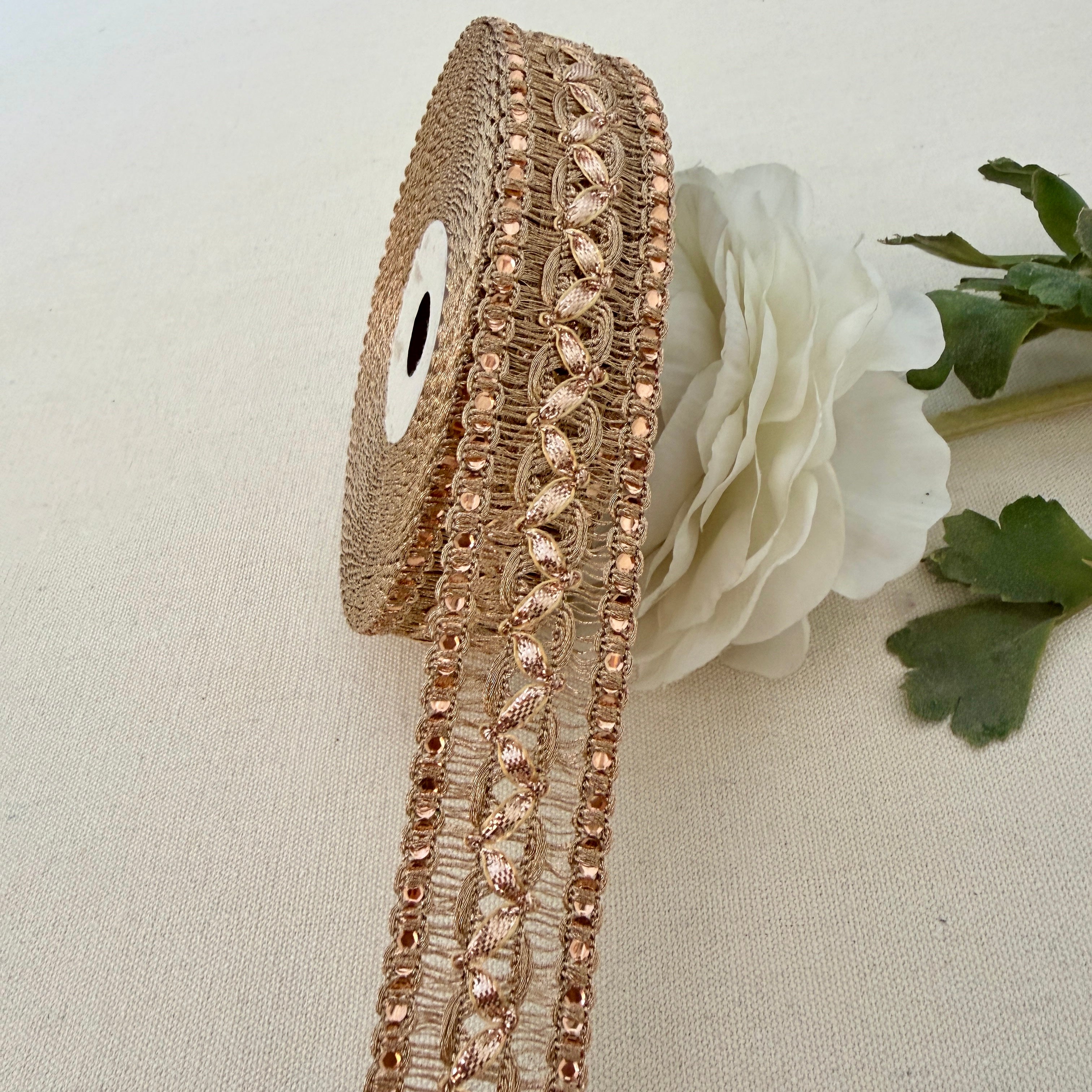Decorative rose gold ribbon with crystals on a white background