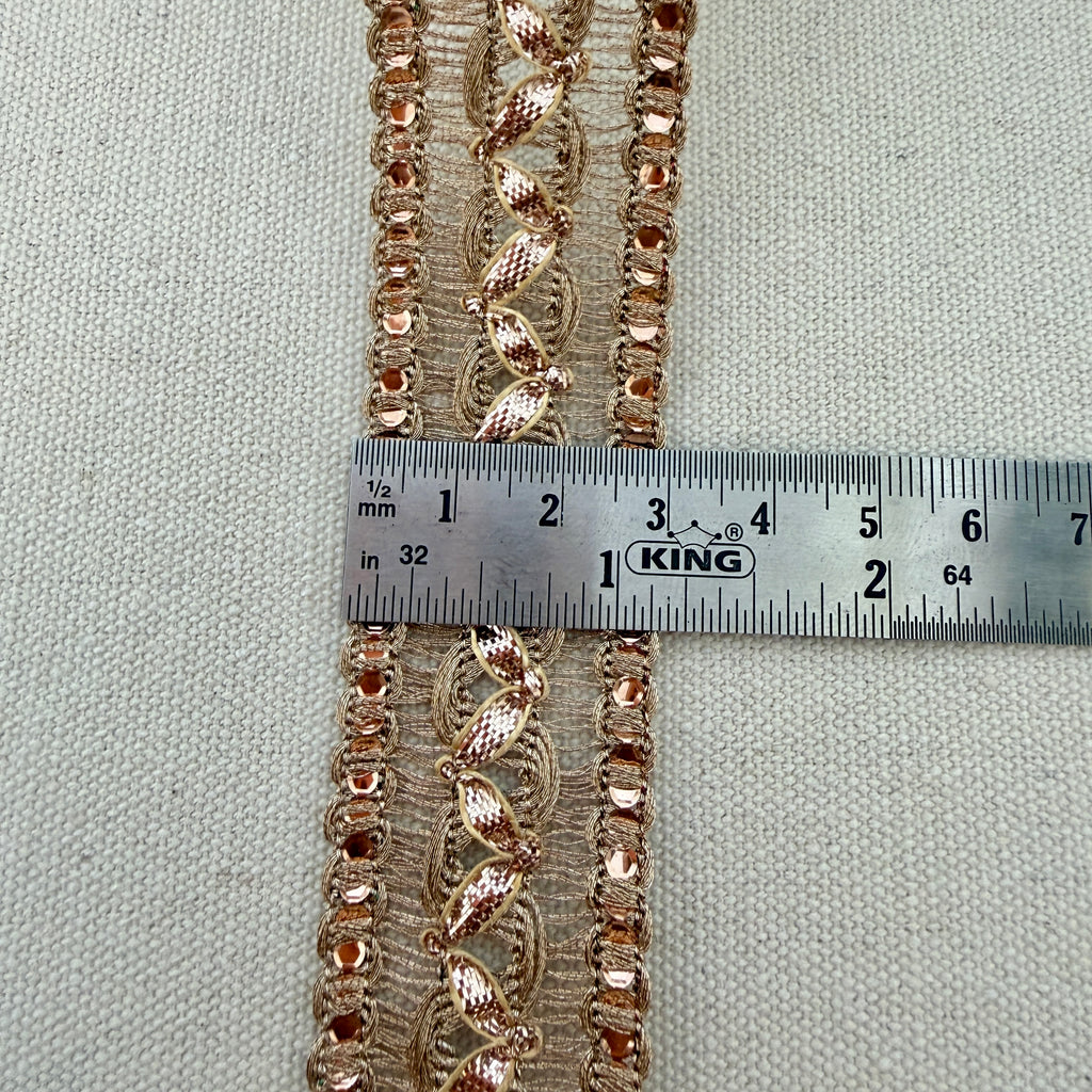 Decorative lace trim with a ruler for measurement on a neutral background