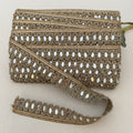 Decorative lace trim with intricate patterns on a beige background