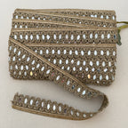 Decorative lace trim with intricate patterns on a beige background