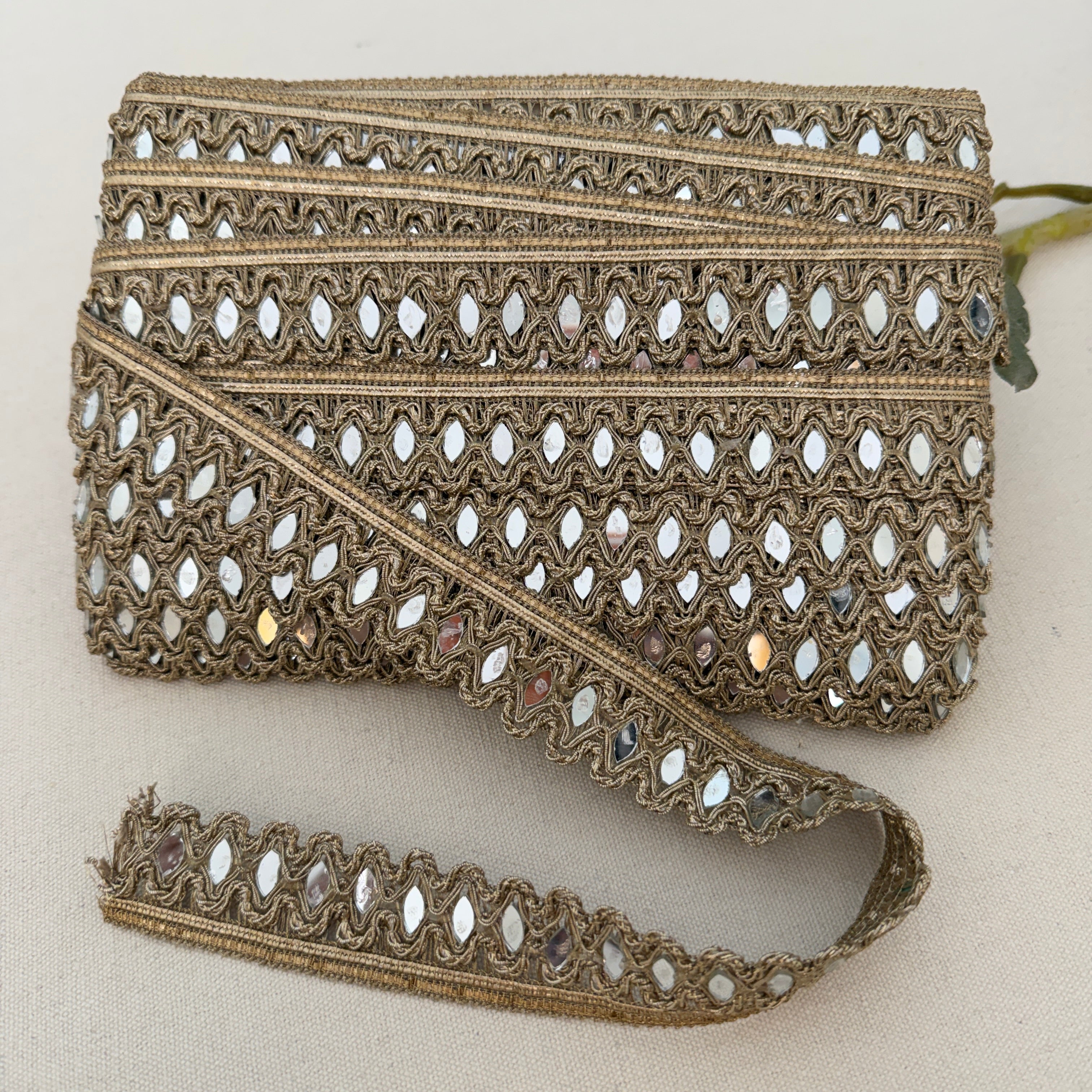 Decorative lace trim with intricate patterns on a beige background