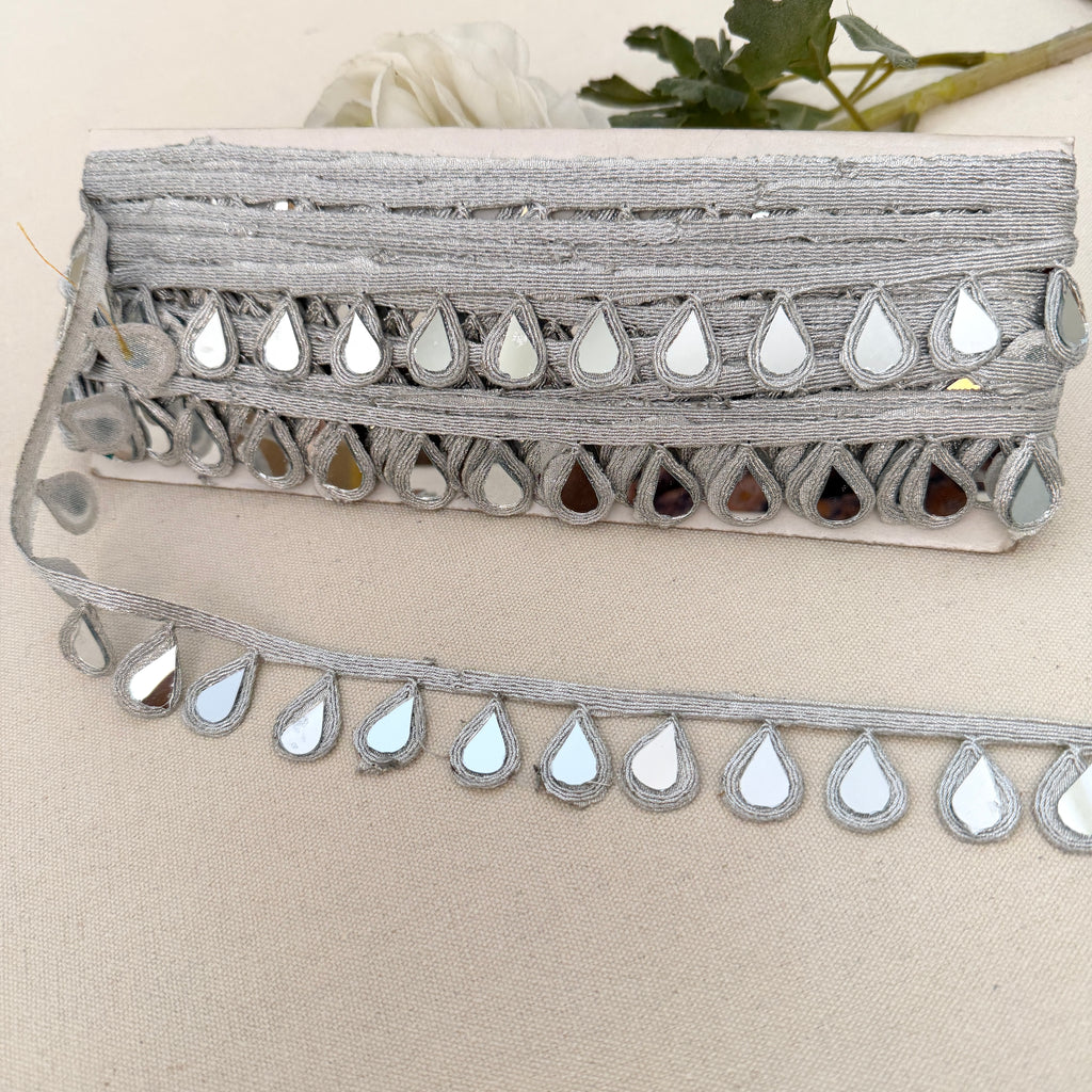 Decorative trim with mirror-like stones on a beige background
