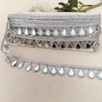 Decorative trim with mirror-like stones on a beige background