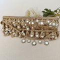 Decorative belt with mirror embellishments on a neutral background