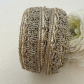 Decorative ribbon roll with intricate patterns on a light background