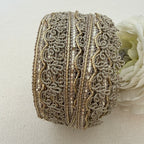 Decorative ribbon roll with intricate patterns on a light background
