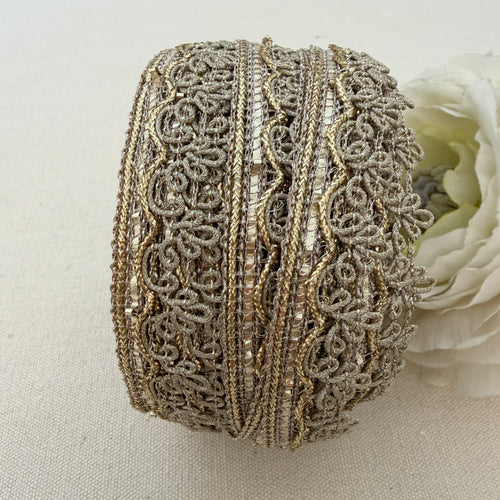 Decorative ribbon roll with intricate patterns on a light background