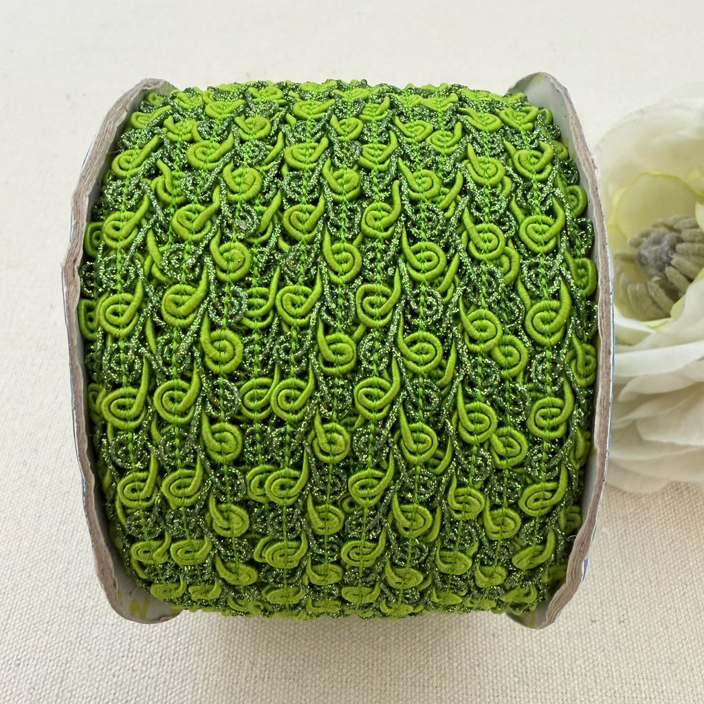 Green textured ribbon roll on a light background