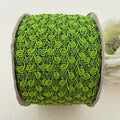 Green textured ribbon roll on a light background