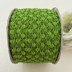 Green textured ribbon roll on a light background