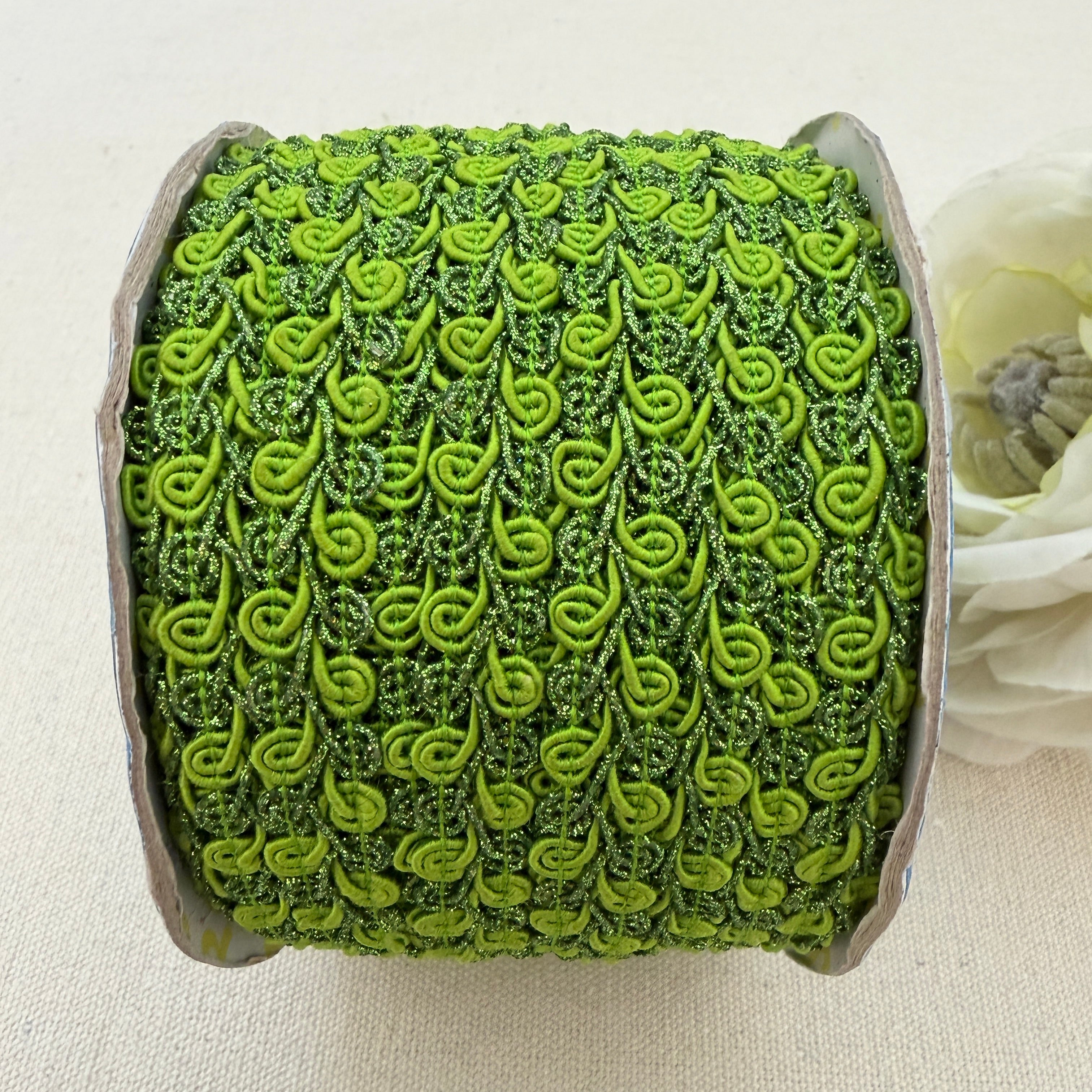 Green textured ribbon roll on a light background