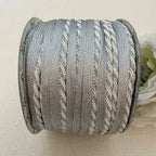 Spool of gray yarn on a beige background