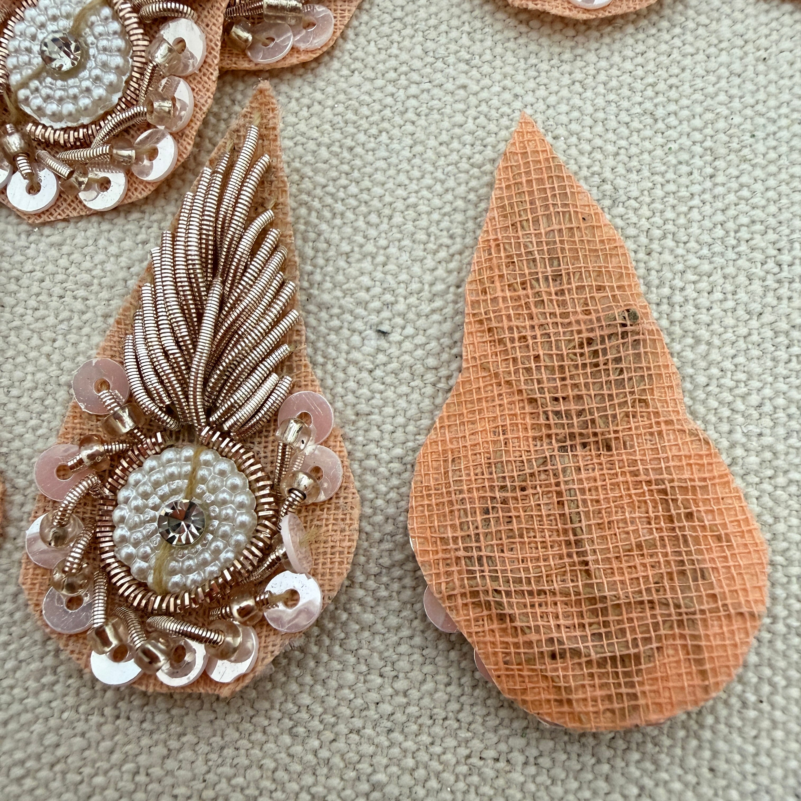 Decorative brooch with intricate design on a textured surface