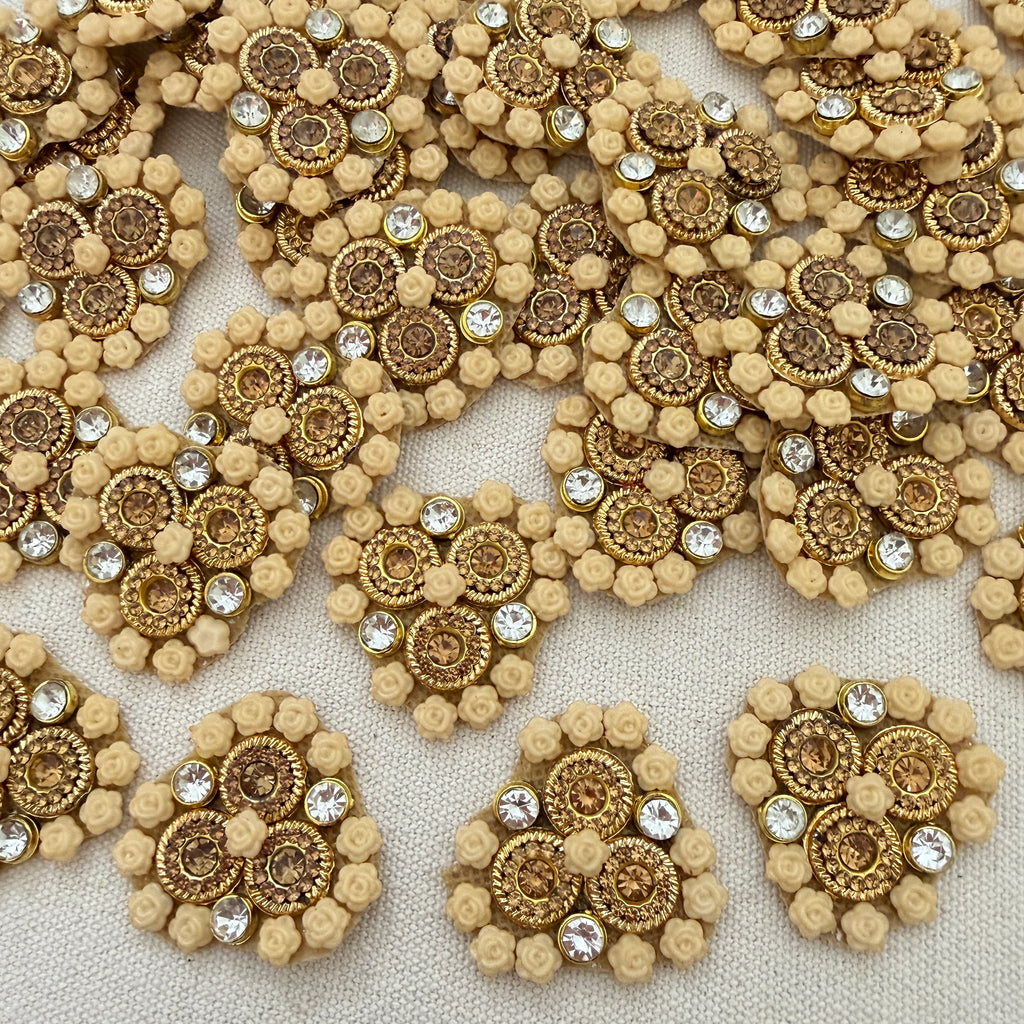 Decorative embellishments with gold and beige patterns on a textured surface