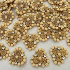 Decorative embellishments with gold and beige patterns on a textured surface