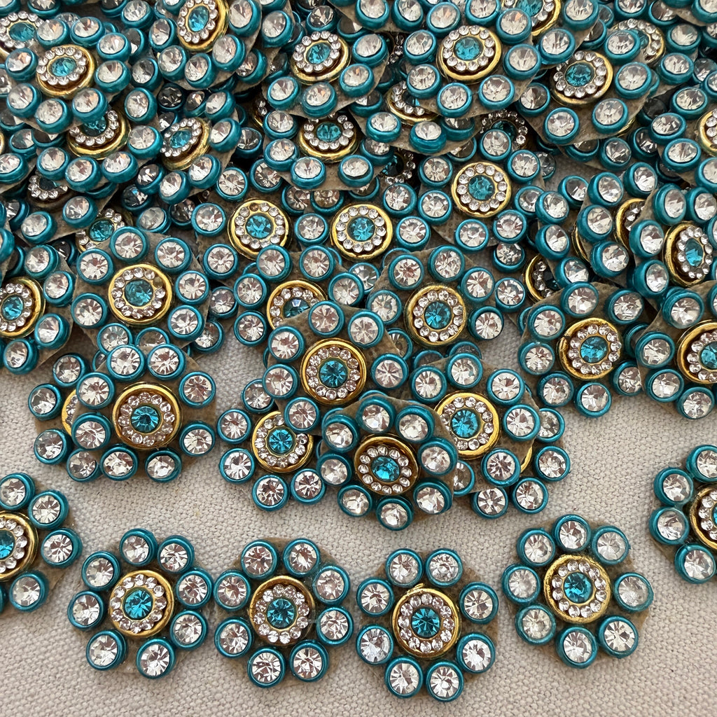Close-up of decorative buttons with blue and gold colors on a textured surface