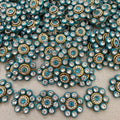 Close-up of decorative buttons with blue and gold colors on a textured surface