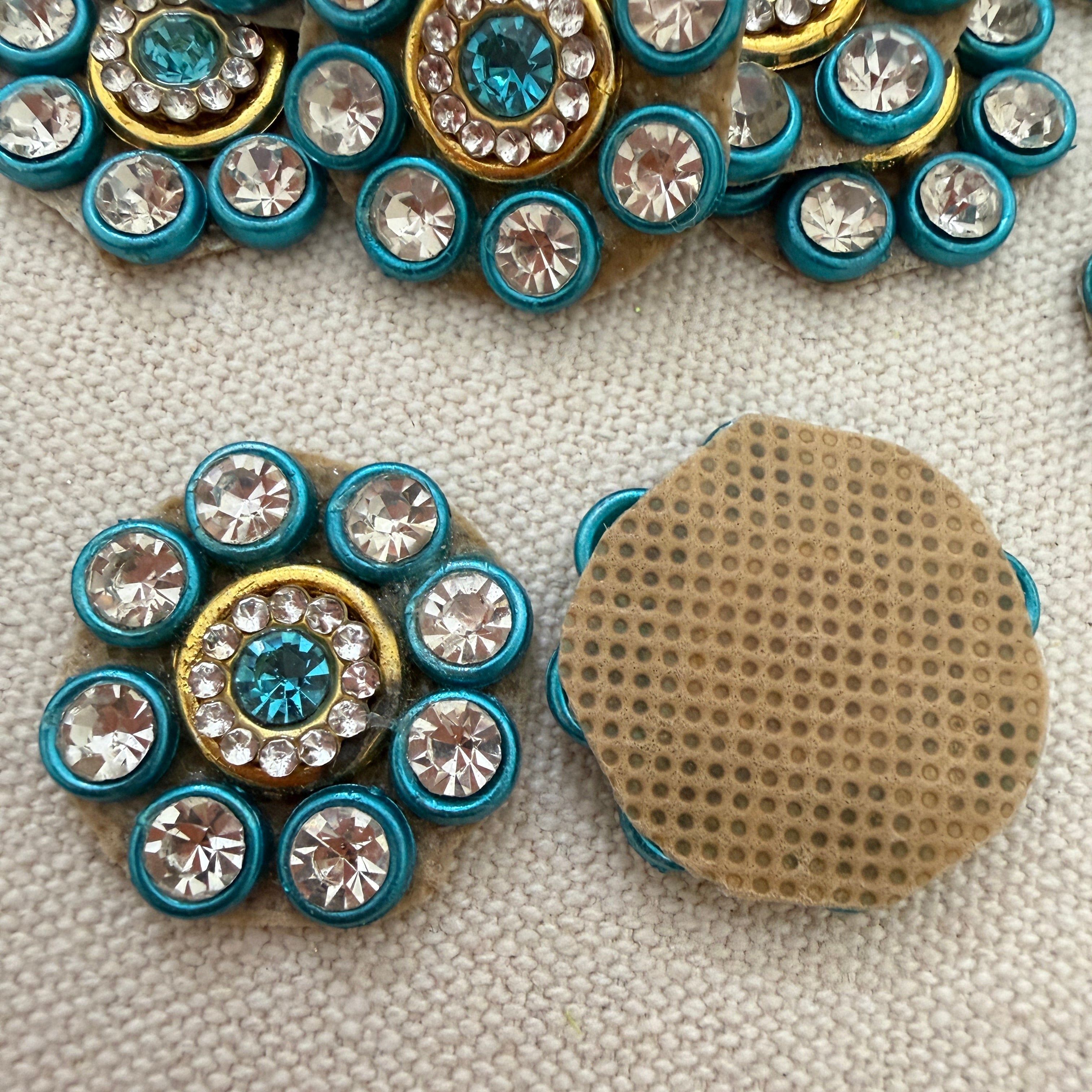 Decorative buttons with gemstones on a textured surface