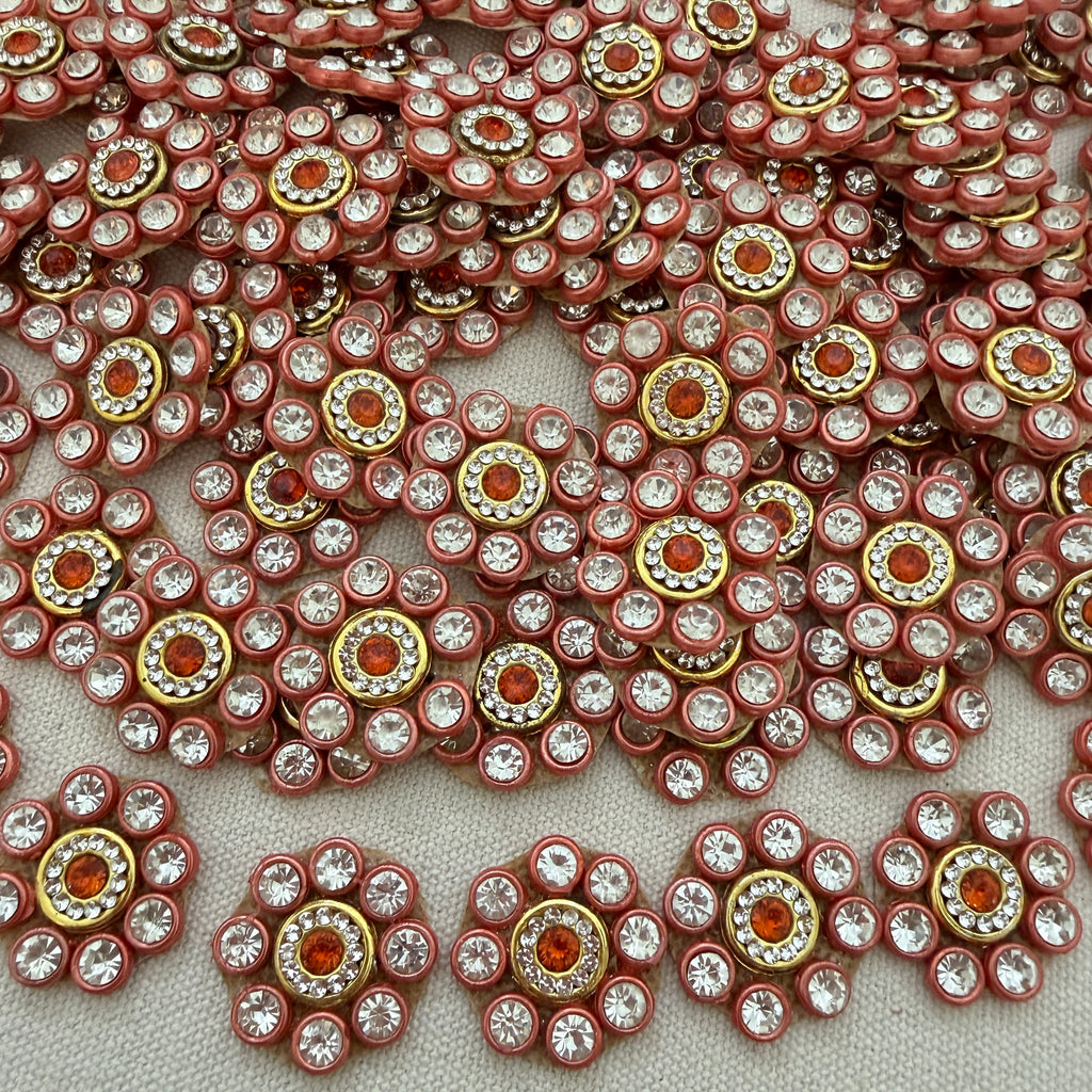 Close-up of decorative embellishments with rhinestones on a light background