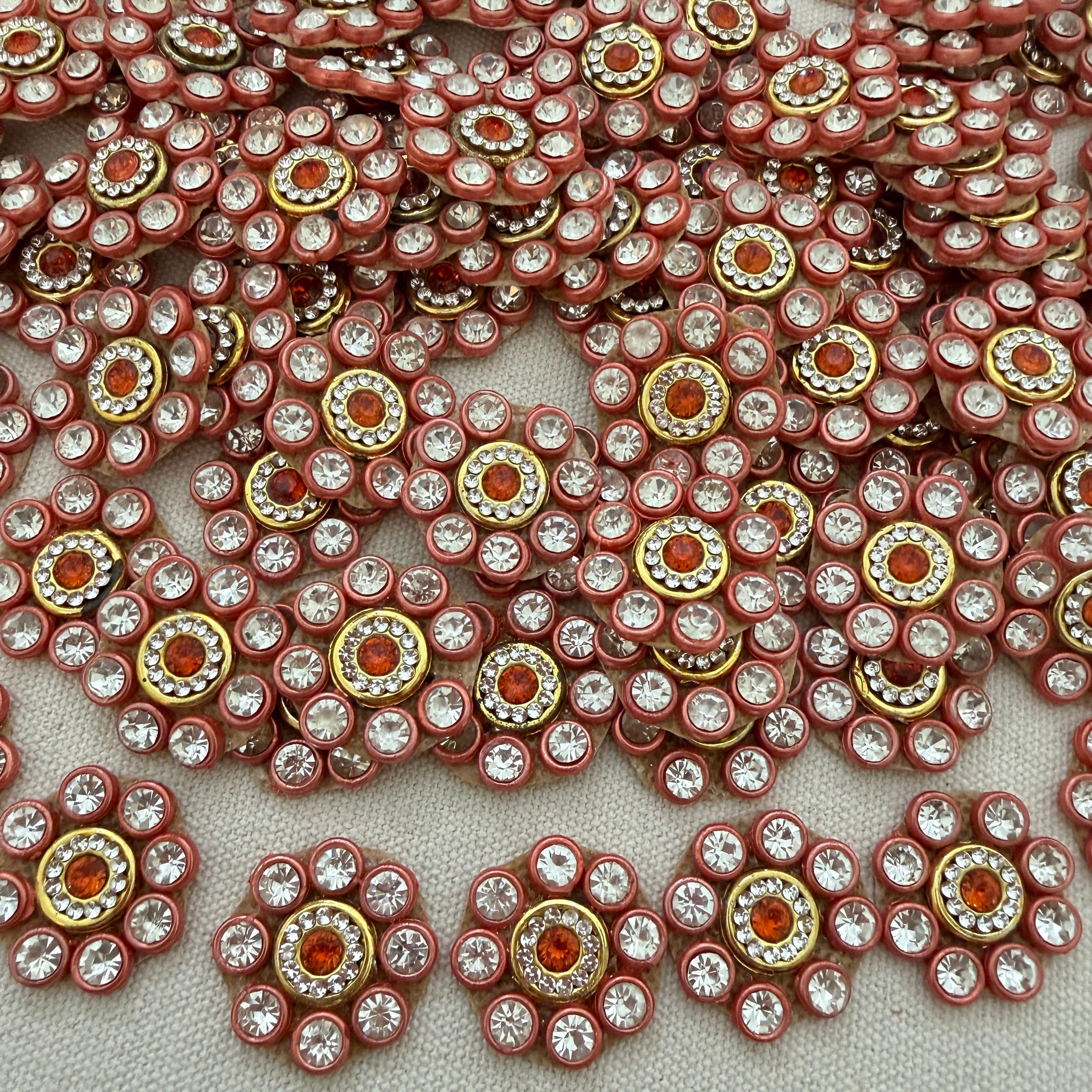 Close-up of decorative embellishments with rhinestones on a light background