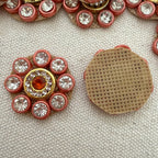 Decorative button with gemstones on a textured surface